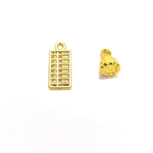 Macro detail of 18K gold-plated abacus and lotus pod charms with polished finish
