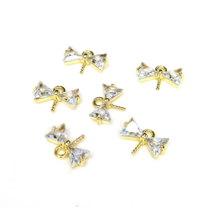 Dettaglio di sei ciondoli a fiocco placcati oro 14k con zirconi cubici scintillanti