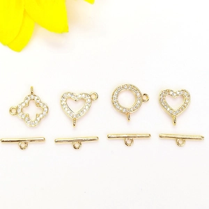 Macro shot of 14K gold plated clover and heart OT toggles with micro-pave cubic zirconia
