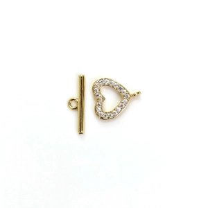 Macro view of a 14K gold-plated heart toggle clasp with micro-pave cubic zirconia crystals