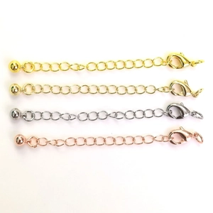 Detail view of four-color lobster clasps and extension chains for DIY jewelry making