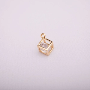 Detailed view of 14K gold plated hollow cube pendant with a micro-set zircon stone inside