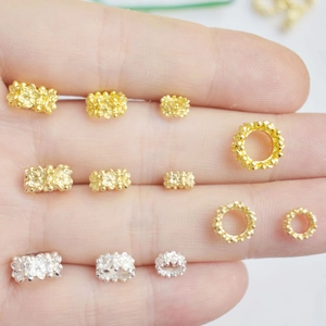 Detail of 14K gold plated hollow floral spacer beads in gold and silver for DIY jewelry