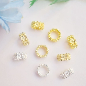 Macro detail of 14K gold-filled hollow flower beads for DIY bracelet jewelry making