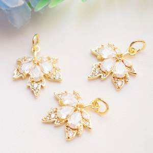 Macro shot of 14K gold-filled maple leaf pendants with micro-pave cubic zirconia details