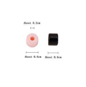 Macro detail of 0.6cm acrylic cylinder beads in pink and black for DIY jewelry making