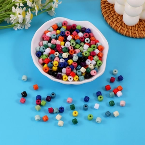 Colorful acrylic barrel beads for DIY jewelry making in a white ceramic bowl