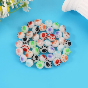 Colorful acrylic cat paw beads for DIY handmade jewelry crafts on a blue background