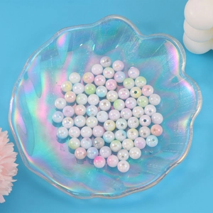 Mix of iridescent acrylic beads in shell tray for DIY necklace and bracelet jewelry making