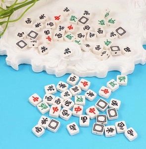 Detailed view of square mahjong beads with traditional characters for DIY jewelry making