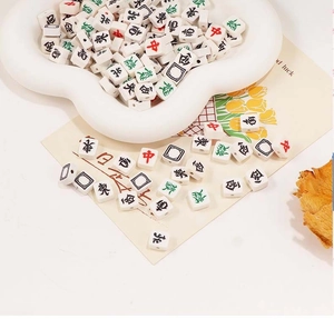 Detailed macro view of white acrylic Mahjong beads with classic characters for DIY jewelry