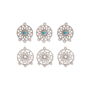 Detailed view of silver dreamcatcher and star charms with turquoise beads for jewelry DIY
