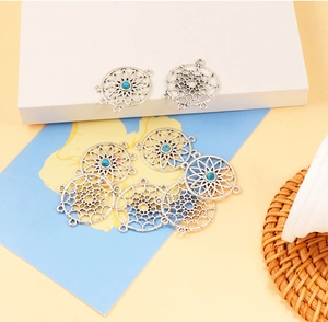 Macro detail of dreamcatcher alloy connectors with blue beads for DIY jewelry making