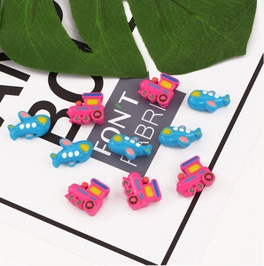 Macro shot of colorful acrylic airplane and train beads for DIY jewelry making crafts