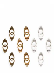 Detailed macro of alloy handcuff charms with FREEDOM engraving in silver and bronze