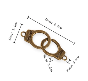 Macro view showing 4.3cm vintage bronze handcuff charm with freedom text and dimensions