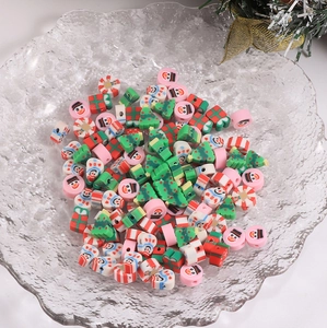 Macro view of Christmas themed polymer clay beads with snowman and tree shapes for DIY jewelry