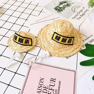 Handwoven straw pet hat with adjustable drawstring and fun yellow tag design