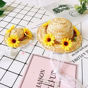 Detail of straw sun hat with yellow sunflower and white lace ties for small pets