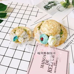 Detailed macro view of handmade pet straw hats with lace ties and fabric floral decor