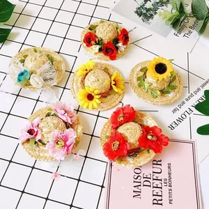 Detail of various mini straw hats with floral and lace decorations for pets or dolls