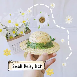 Handcrafted pet straw hat with green leaf trim and white daisy flower for cats and dogs