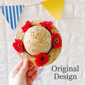 Handwoven pet straw hat with red floral accents and white lace tie for dogs and cats