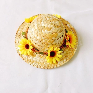 Handwoven straw hat for dogs and cats with vibrant yellow sunflowers in pastoral summer style