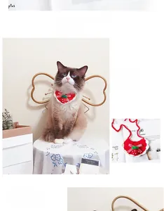Detailed knit strawberry pet bib with red bow for cats and dogs on a Ragdoll cat