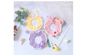 Handmade crochet pet bib with floral patterns in yellow, pink and purple colors