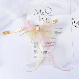 Close-up of rainbow organza pet bow collar featuring a white pearl and quick-release buckle