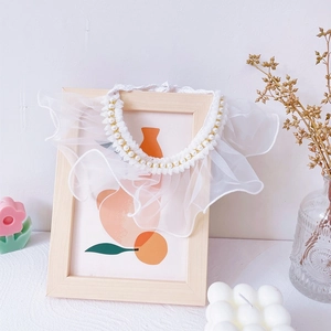 Detail of white lace pet collar with faux pearls and layered ruffle design for cats