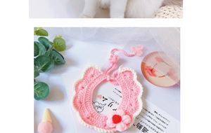 Macro view of handmade pink crochet flower pet bib with intricate knit petal details