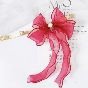 Detail of red organza bow pet collar with center pearl and adjustable buckle