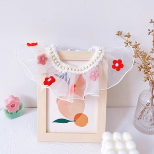 Close-up of white chiffon pet collar with faux pearls and cute felt flower accents
