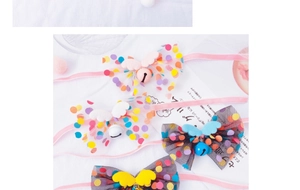 Close-up of mesh pet collars with fairy wings and colorful bells in multiple soft colors