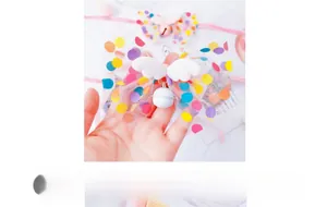 Detail of fairy wing cat collar with colorful polka dot mesh bow and metal bell