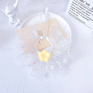 Detailed view of white floral lace pet collar with yellow crochet flower and pearl center