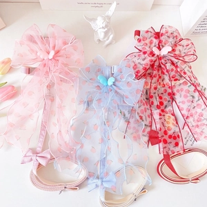 Detail of elegant pet harness with large organza bow and cherry peach patterns