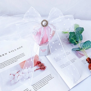 Detail of white organza bow pet collar with pearl accent and vintage base for cats and dogs