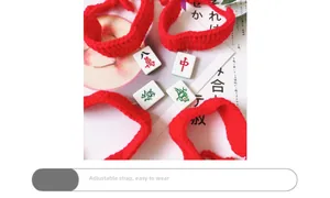 Detail of red handmade knit pet collars with traditional mahjong tile pendants