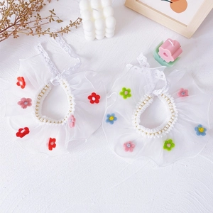 Detail of lace pet collar with colorful felt flowers and pearl trim for cats