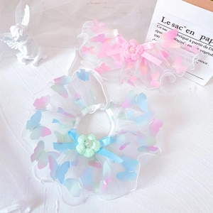 Detailed view of layered lace pet collars with butterfly patches and floral lace bows