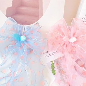Detailed view of peach-patterned organza pet bow collars with adjustable straps and wings