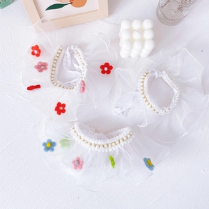Detailed close-up of three lace pet collars with faux pearls and colorful felt flowers