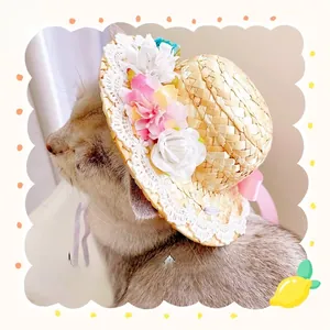 Detail of pet straw hat with lace edge, fabric flowers and pink bow on a cat