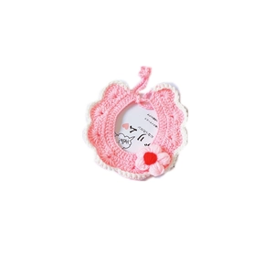 Pink hand-knitted pet collar with white scalloped edges and 3D floral decoration