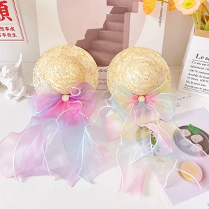 Detail of pet straw hat featuring macaron organza ribbon bows and pearl buckle accents