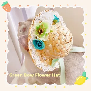 Detail of pet straw hat with artificial flowers and lace trim worn by a cat