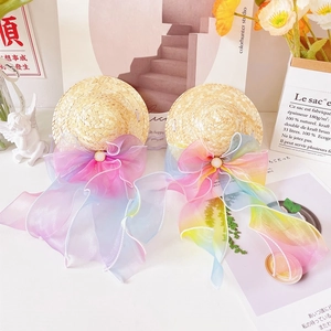Detail of small pet straw hats featuring large rainbow organza bows and pearl accents